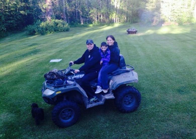 Family on an ATV in their yard
