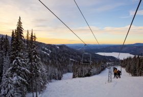 Riding a chairlift at sunset.