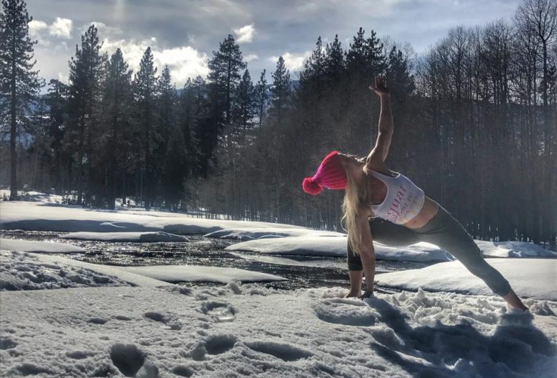 Woman doing yoga in the snow