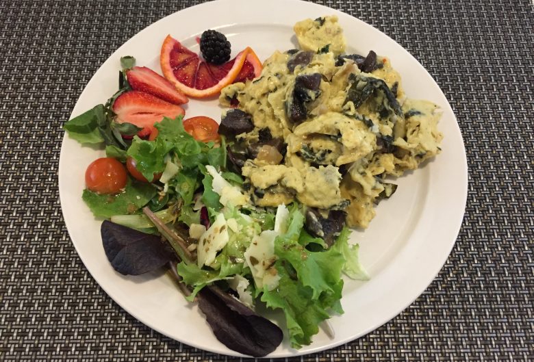 scrambled eggs with salad and fruit