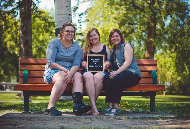 three women on park bench