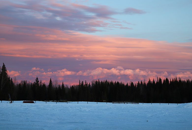 sunset over snowy field